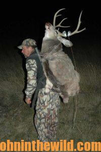 Hunter carrying a downed deer