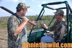 Two hunters talk in the field