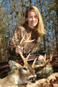 A hunter with her downed deer