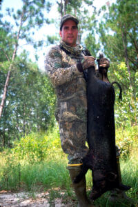 A hunter with his downed hog