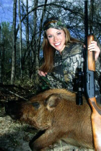A hunter with her downed hog