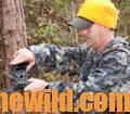 A hunter checks his trail camera