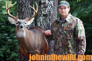 A hunter with a mounted buck