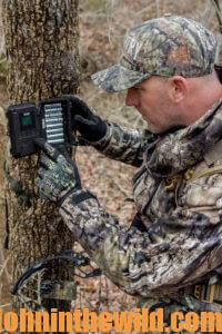 A hunter checks his trail cameras
