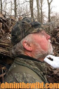 A hunter looks in the sky for signs of waterfowl