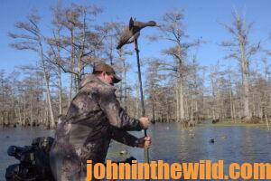 A hunter holds a spinning wing duck decoy