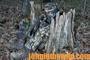 A hunter waits in the woods for a turkey to approach