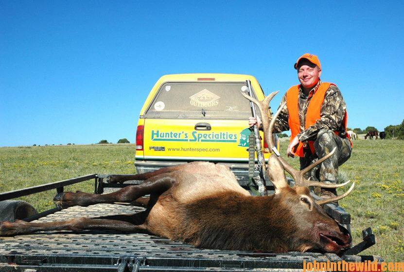 Hunter standing with elk