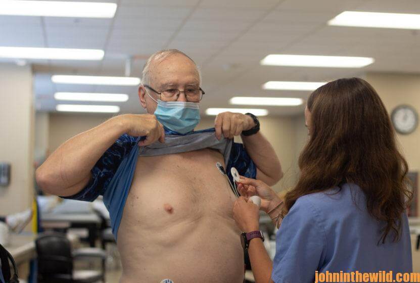 John E. Phillips being hooked up to a heart monitor