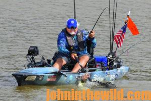 McElroy reels in a fish from his kayak