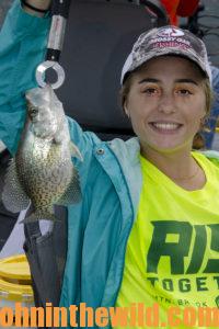 Abbey hold up a fish she caught