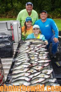 Everyone poses with the fish they caught from the bad-weather fishing trip