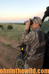 Hunter looks through a pair of binoculars