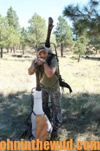 Hunter pauses for a photo as he packs out his elk