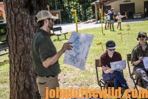 An instructor goes over a map of where students can hunt