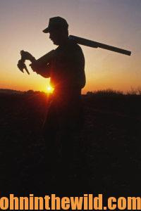 A hunter retrieves his downed bird