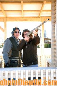 Two sharpshooters practice at the range wearing protective eyewear and ear protection