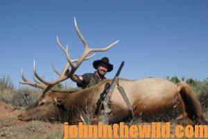 A hunter poses with his downed elk