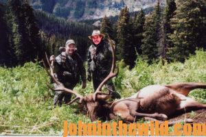 Two hunters with a downed elk