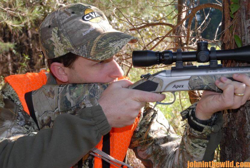 Hunter aims with his rifle