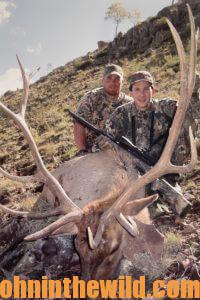 Two hunter pose with their downed elk