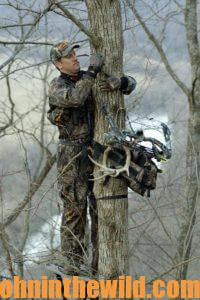 A hunter climbing into a tree stand