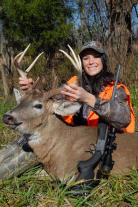 A hunter with her downed deer