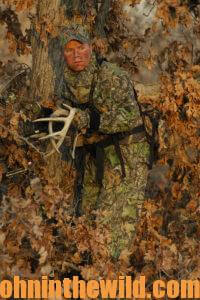 A hunter in the woods rattling antlers