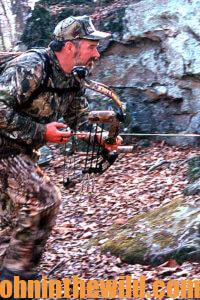 A hunter moves quietly and quickly with his bow