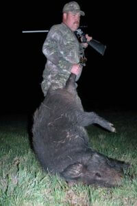 A hunter with his downed hog