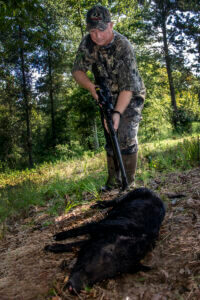 A hunter retrieves his downed hog