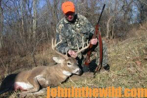 A hunter with his downed deer
