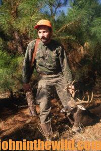 A hunter with his downed deer