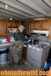 A hunter cooks up a meal on the stovetop