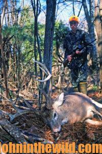 A hunter retrieves his downed deer