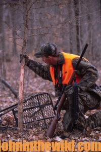 A hunter looking at deer sign
