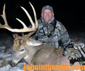 A hunter with his downed deer