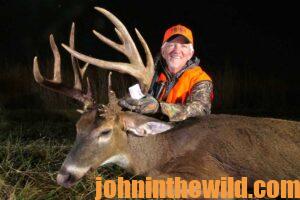 A hunter with his downed deer