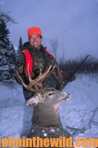 A hunter with his downed deer