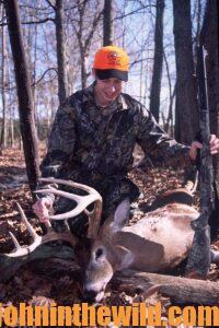 A hunter with his downed deer