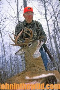 A hunter with his downed deer