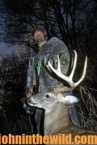 A hunter with his downed deer