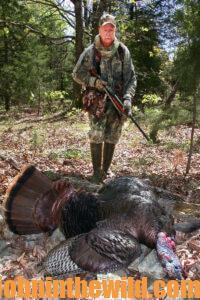 A hunter retrieves his downed turkey