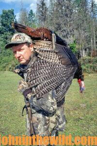 A hunter carries his downed bird