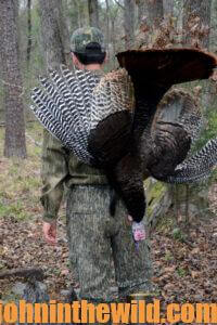 A hunter carries his downed bird