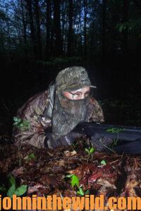 A hunter lies in wait for a gobbler to cross his path