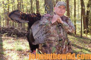 A hunter carries his downed turkey