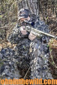 A hunter looks through his scope for a turkey