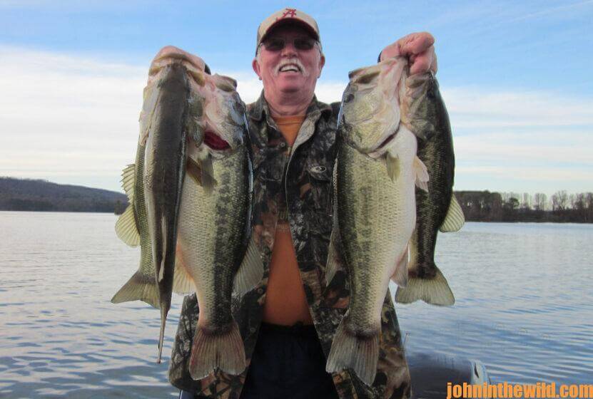 An angler shows off a large catch of bass
