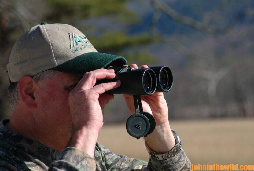 A hunter scouts out the area for turkeys